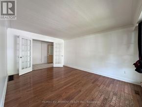 Hamilton (Balfour) apartment for rent - A room with wooden flooring and white walls, with a door and a window.
