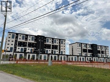 Lasalle townhouse for rent - A large building under construction with a fence around it.