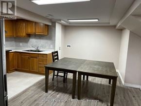 Mississauga (Erin Mills) apartment for rent - A kitchen with wooden cabinets and a table.