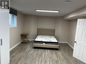 Mississauga (Erin Mills) apartment for rent - A bedroom with a bed, nightstand, and window.