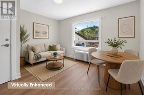 Grimsby (Grimsby East) apartment for rent - A living room with a couch, chairs, and a table with a vase of flowers on it.