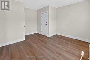Grimsby (Grimsby East) apartment for rent - A room with a wooden floor and a white door.