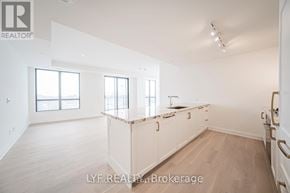 Toronto (Englemount-Lawrence) condo for rent - A white interior of a room with wooden floors and a window.
