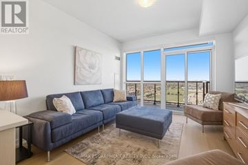 Mississauga (Central Erin Mills) condo for rent - A living room with a blue couch and a large window.