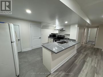 Toronto (Dorset Park) apartment for rent - A kitchen with a refrigerator, sink, and stove top.