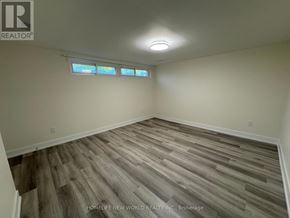 Toronto (Dorset Park) apartment for rent - A room with wooden flooring and a window with blinds.