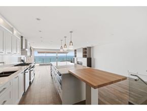 White Rock apartment for rent - A modern kitchen with a wooden countertop and stainless steel appliances.