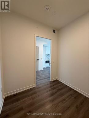 Vaughan (Vaughan Corporate Centre) condo for rent - A room with a wooden floor and white walls.