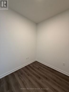 Vaughan (Vaughan Corporate Centre) condo for rent - A room with white walls and wood flooring.