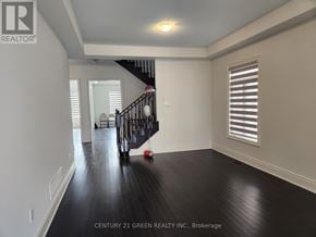 Whitchurch-Stouffville (Stouffville) apartment for rent - A spacious room with a staircase and a window with blinds.
