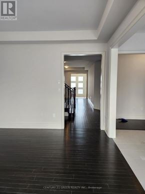 Whitchurch-Stouffville (Stouffville) apartment for rent - A hallway with a wooden floor and white walls.