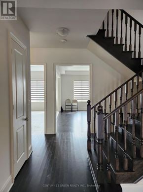 Whitchurch-Stouffville (Stouffville) apartment for rent - A hallway with a staircase and a chair.