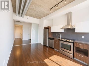 Ottawa condo for rent - A kitchen with wooden floors and stainless steel appliances.