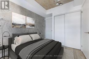 Toronto (Church-Yonge Corridor) condo for rent - A bedroom with a bed, a nightstand, and a painting on the wall.