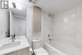 Toronto (Church-Yonge Corridor) condo for rent - A white bathroom with a marble wall and a toilet in the corner.