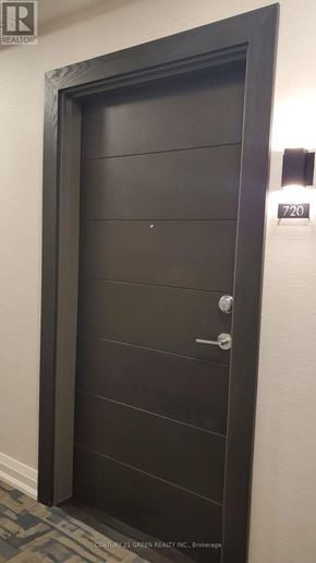 Hamilton (Beasley) condo for rent - A brown door with a silver handle and a number 720 on the wall above it.