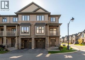 Stoney Creek townhouse for rent - A large, multi-story residential building with a realtor logo on the top left.