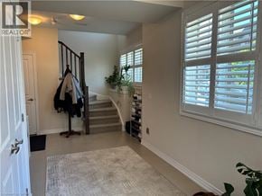 Stoney Creek townhouse for rent - A hallway with a coat rack and a potted plant.