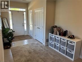Stoney Creek townhouse for rent - A hallway with a white cabinet and a rug on the floor.