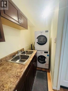 Coquitlam apartment for rent - A small laundry room with a washer and dryer stacked on top of each other.
