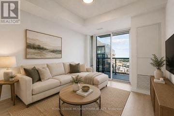 Burlington (Alton) condo for rent - A living room with a couch, a coffee table, and a painting on the wall.