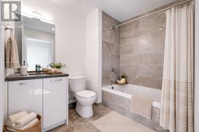Toronto (Moss Park) condo for rent - A bathroom with a toilet, sink, and bathtub.