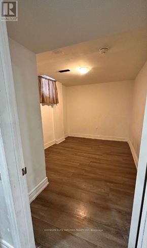 Ajax (Central West) apartment for rent - A room with wooden flooring and white walls.
