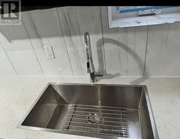 Ajax (Central West) apartment for rent - A stainless steel kitchen sink with a faucet.