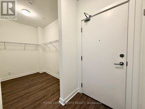 Clarington (Bowmanville) condo for rent - A white door with a black handle is closed.