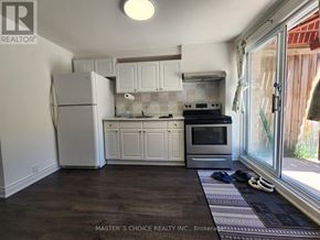 Vaughan (Patterson) apartment for rent - A kitchen with white appliances and cabinets.