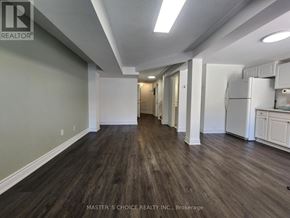 Vaughan (Patterson) apartment for rent - A spacious room with wooden flooring and white walls.