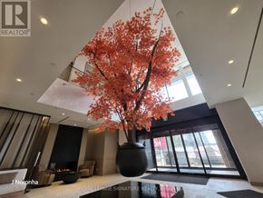 Mississauga (City Centre) condo for rent - A large vase with a tree in it is in the middle of a room.