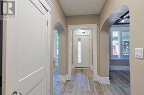 London East (East G) fourplex for rent - A hallway with a white door and a window.