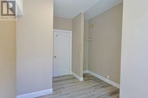 London East (East G) fourplex for rent - A room with a white door and a wooden floor.