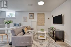 Hamilton (Rosedale) apartment for rent - A living room with a grey couch, a white coffee table, and a flat screen TV mounted on the wall.