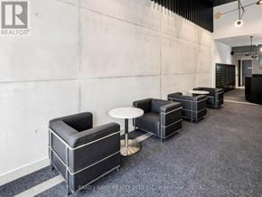 Toronto (Moss Park) condo for rent - A modern office space with black and white furniture.