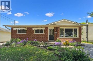 Guelph apartment for rent - A house with a well-maintained front yard.