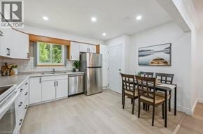 Guelph apartment for rent - A kitchen with white cabinets and a wooden table.