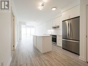 Mississauga (Clarkson) condo for rent - A modern kitchen with stainless steel appliances and white cabinets.