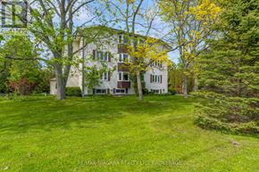 Pelham (Fenwick) multi-family for rent - A large white house with a green lawn in front.