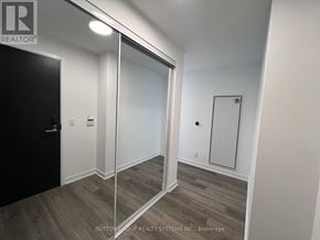 Toronto (Moss Park) condo for rent - A room with a glass door and a wooden floor.