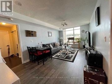 Toronto (Niagara) condo for rent - A living room with a dining table and chairs.