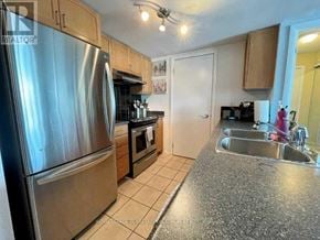 Toronto (Niagara) condo for rent - A kitchen with a stainless steel refrigerator and a sink.
