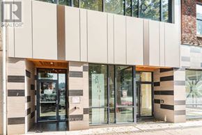 Hamilton (Beasley) condo for rent - The image shows a building with a modern design, featuring a combination of white and beige panels, and glass doors.