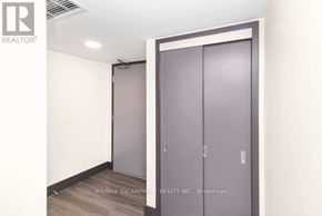 Hamilton (Beasley) condo for rent - A brokerage office with a wall of wood paneling and a door.