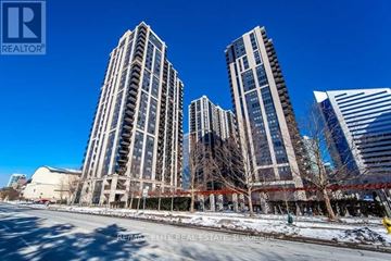 Toronto (Lansing-Westgate) condo for rent - A city street with three tall buildings and a clear blue sky.