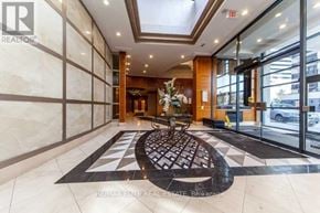 Toronto (Lansing-Westgate) condo for rent - A lobby with a large rug and a glass door.