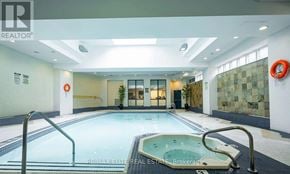 Toronto (Lansing-Westgate) condo for rent - A large indoor swimming pool with a hot tub in the middle.