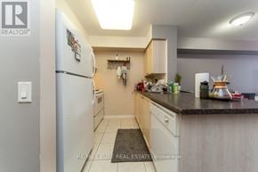 Toronto (Lansing-Westgate) condo for rent - A kitchen with a white refrigerator and wooden cabinets.