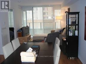 Toronto (Bay Street Corridor) condo for rent - A dining room with a black table and white chairs.